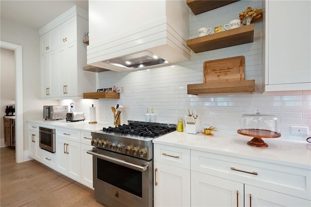 920 Wemberley Ln, Marietta, GA 30064 - kitchen featuring open shelves, stainless steel stove, custom exhaust hood, white cabinetry, and decorative backsplash