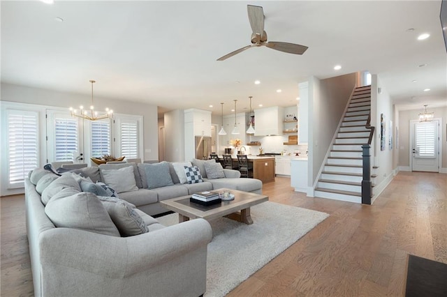 920 Wemberley Ln, Marietta, GA 30064 - living area featuring a chandelier, stairs, a ceiling fan, light wood-type flooring, and baseboards