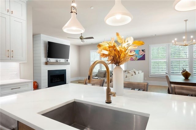 920 Wemberley Ln, Marietta, GA 30064 - kitchen with a sink, open floor plan, ceiling fan, and light countertops