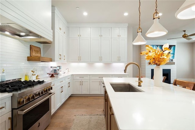 920 Wemberley Ln, Marietta, GA 30064 - kitchen featuring a sink, high end stove, premium range hood, backsplash, and light countertops