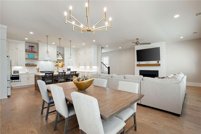 920 Wemberley Ln, Marietta, GA 30064 - dining area with ceiling fan, recessed lighting, light wood finished floors, a large fireplace, and a chandelier