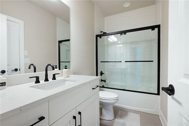 920 Wemberley Ln, Marietta, GA 30064 - full bath featuring vanity, toilet, combined bath / shower with glass door, and tile patterned flooring