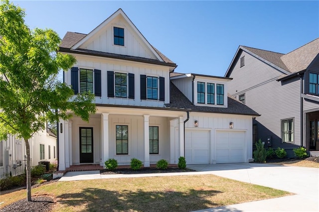 920 Wemberley Ln, Marietta, GA 30064 - modern farmhouse featuring board and batten siding, covered porch, driveway, roof with shingles, and a garage
