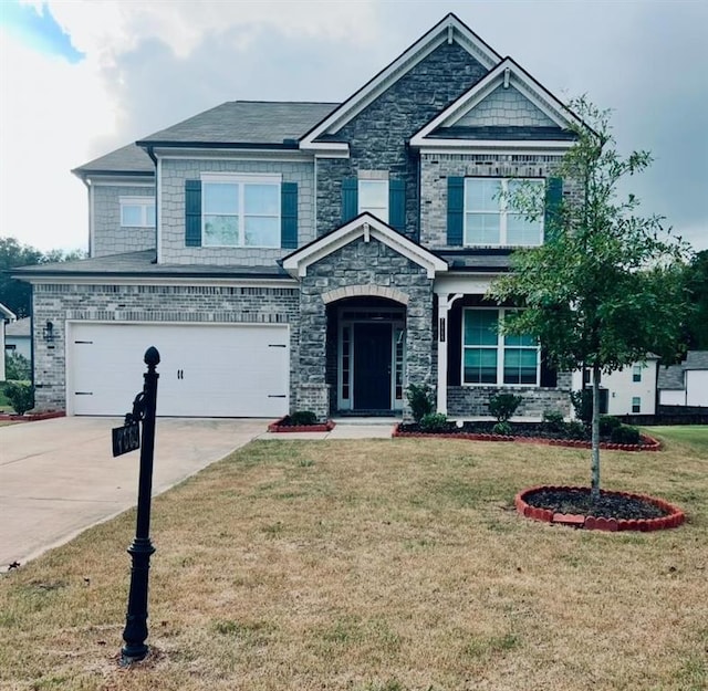 craftsman house with a garage and a front yard