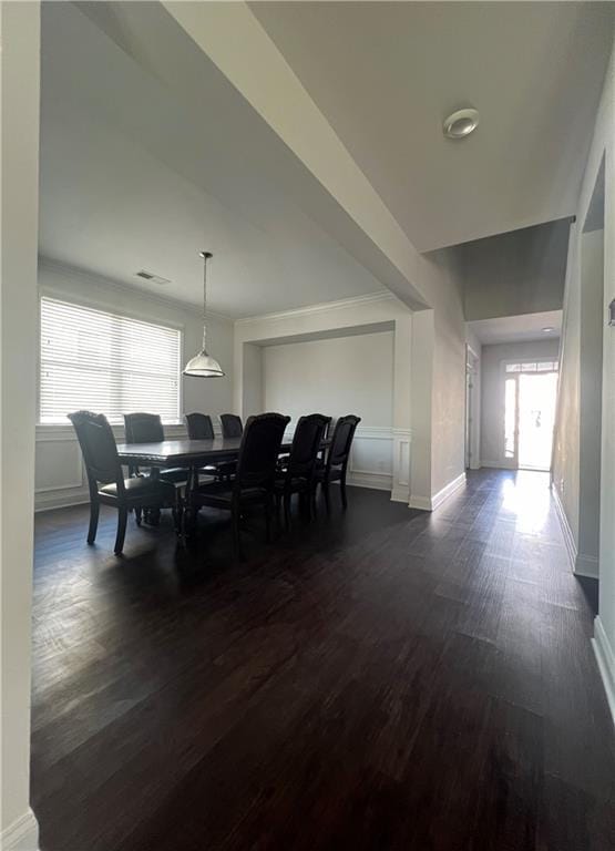 dining space with dark hardwood / wood-style floors and a healthy amount of sunlight