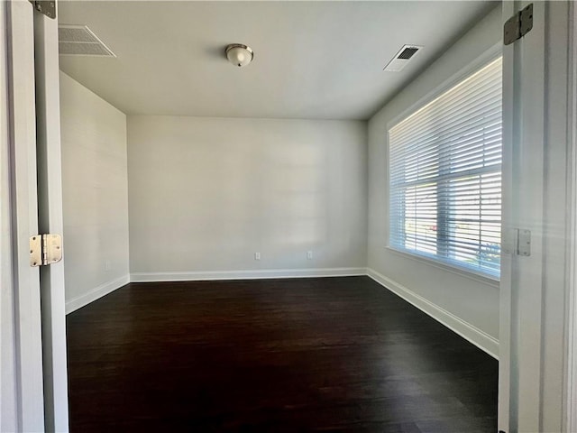 unfurnished room with dark hardwood / wood-style floors