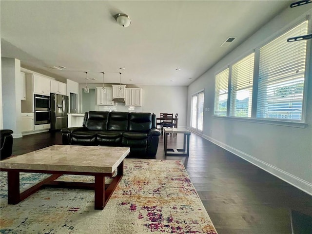 living room with dark hardwood / wood-style flooring