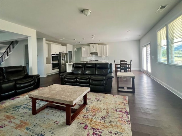 living room with dark hardwood / wood-style flooring