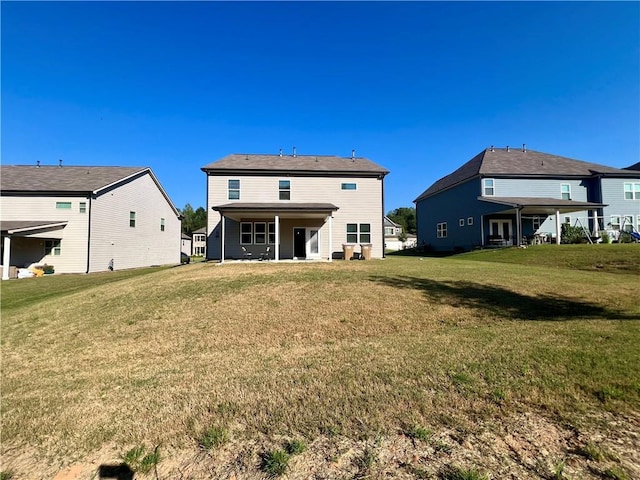 back of house with a lawn