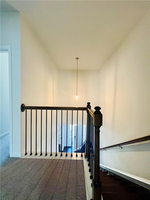 bedroom with a tray ceiling and light colored carpet