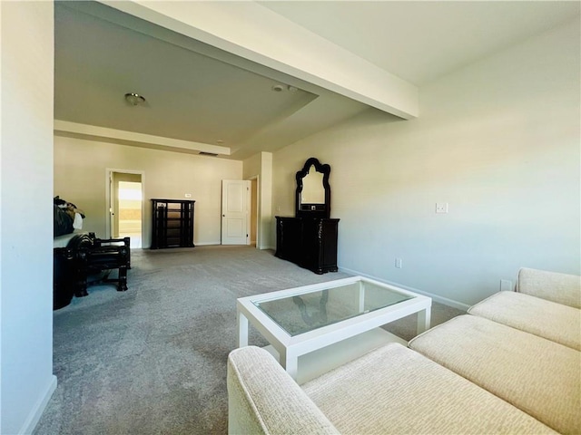 carpeted living room featuring beamed ceiling