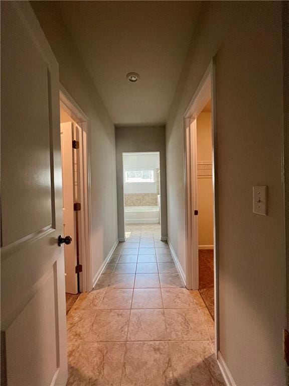 corridor featuring light tile patterned flooring