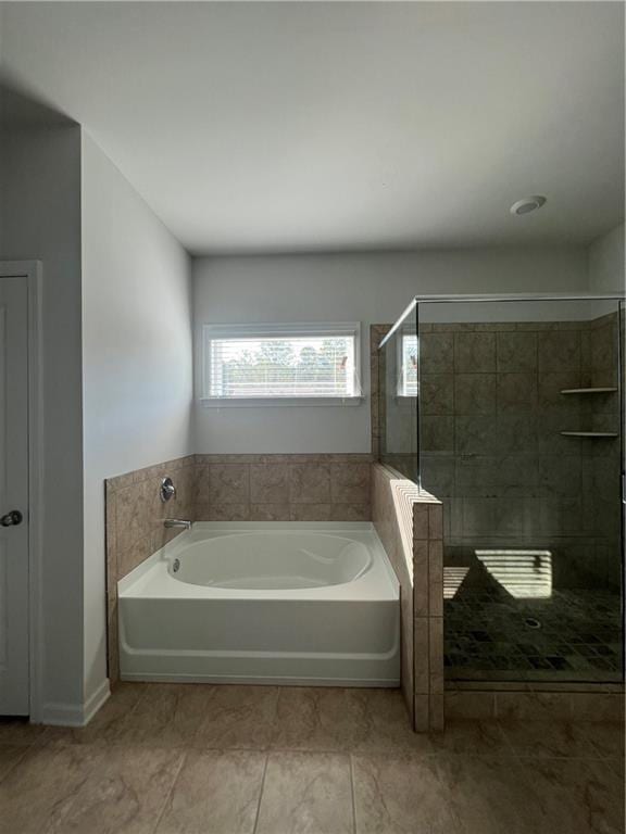 bathroom featuring separate shower and tub