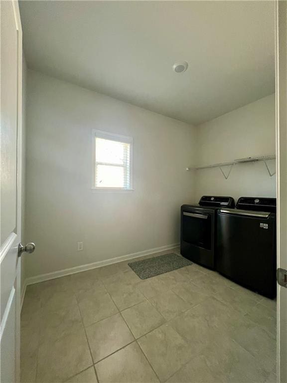 washroom featuring washing machine and clothes dryer and light tile patterned flooring