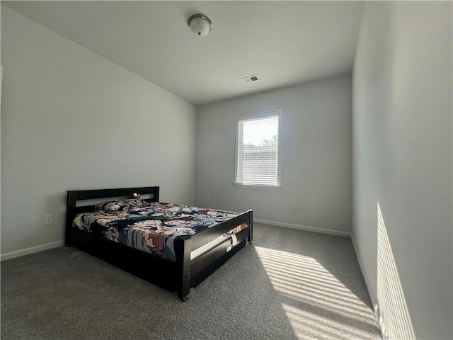 bedroom with dark colored carpet