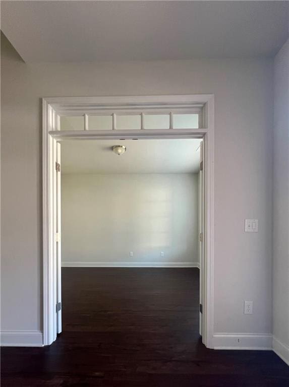 corridor with dark wood-type flooring