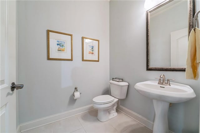 bathroom featuring toilet, tile patterned floors, and sink