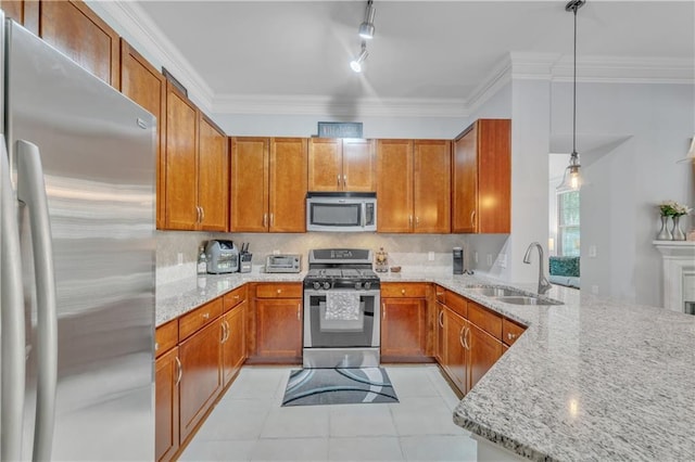 kitchen with sink, hanging light fixtures, light stone countertops, kitchen peninsula, and stainless steel appliances