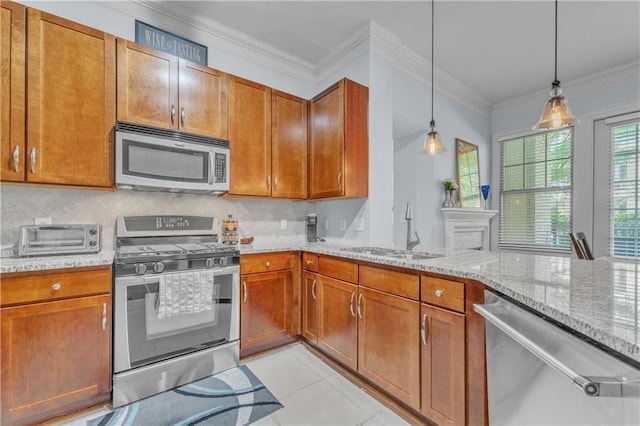 kitchen featuring light stone countertops, stainless steel appliances, sink, pendant lighting, and light tile patterned floors