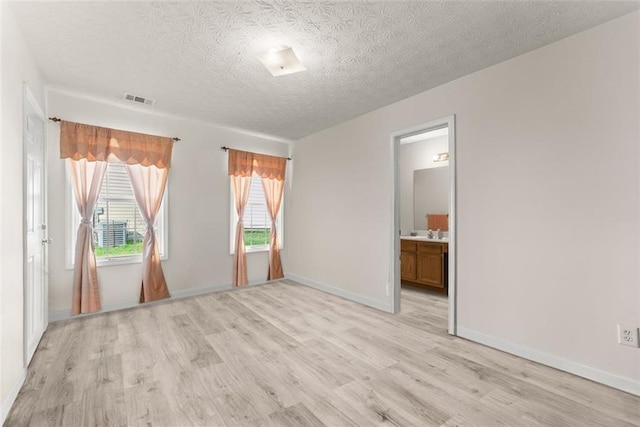 2428 Buena Vista Cir, Gainesville, GA 30504 - unfurnished room featuring light wood-style flooring, a textured ceiling, and baseboards