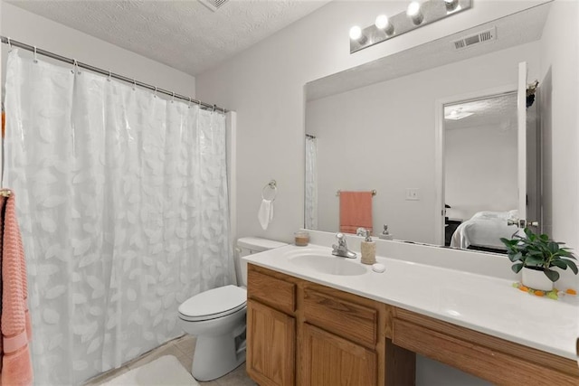 2428 Buena Vista Cir, Gainesville, GA 30504 - ensuite bathroom featuring toilet, vanity, a textured ceiling, tile patterned floors, and a shower with curtain