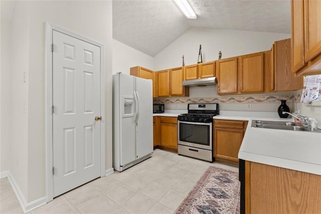 2428 Buena Vista Cir, Gainesville, GA 30504 - kitchen featuring white refrigerator with ice dispenser, gas range, under cabinet range hood, a sink, and a textured ceiling