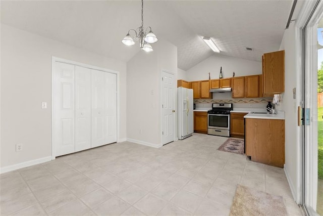 2428 Buena Vista Cir, Gainesville, GA 30504 - kitchen with gas stove, white fridge with ice dispenser, brown cabinets, light countertops, and vaulted ceiling