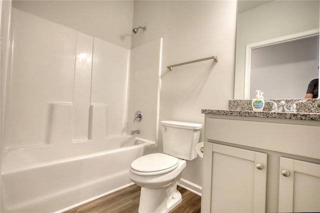 full bathroom featuring vanity, hardwood / wood-style floors, bathtub / shower combination, and toilet