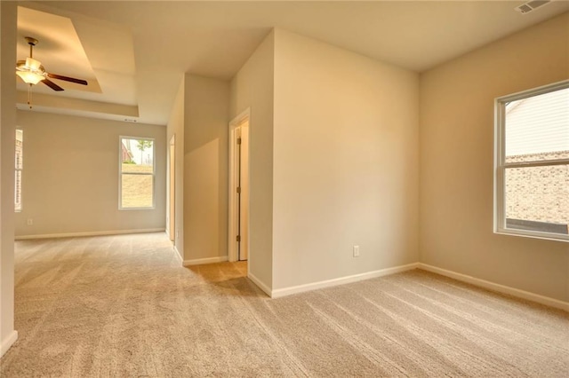 carpeted spare room with ceiling fan