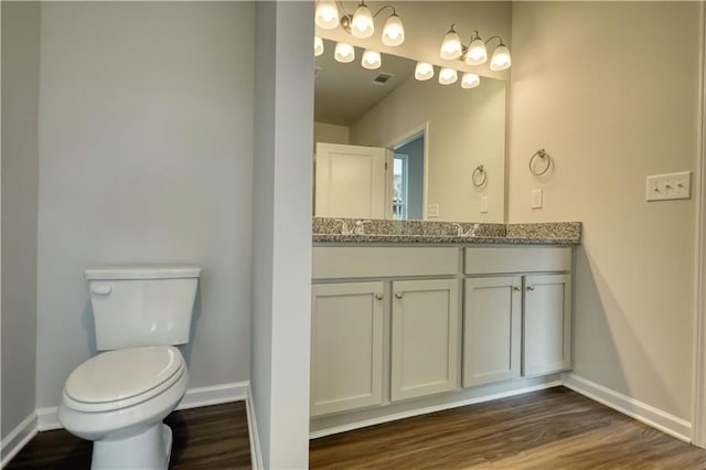 bathroom featuring hardwood / wood-style flooring, vanity, and toilet