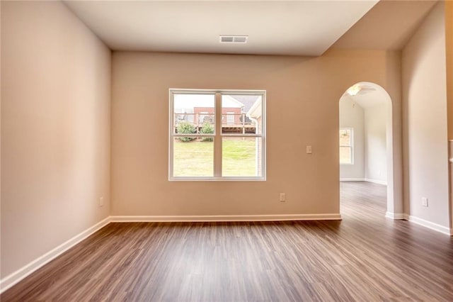 unfurnished room with dark wood-type flooring