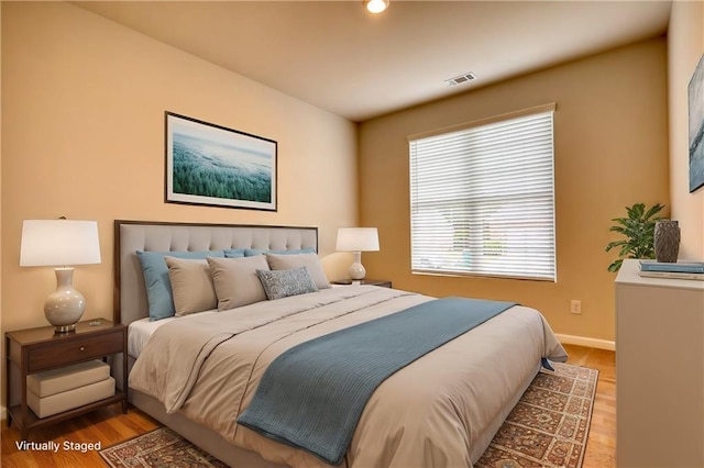 bedroom with hardwood / wood-style floors