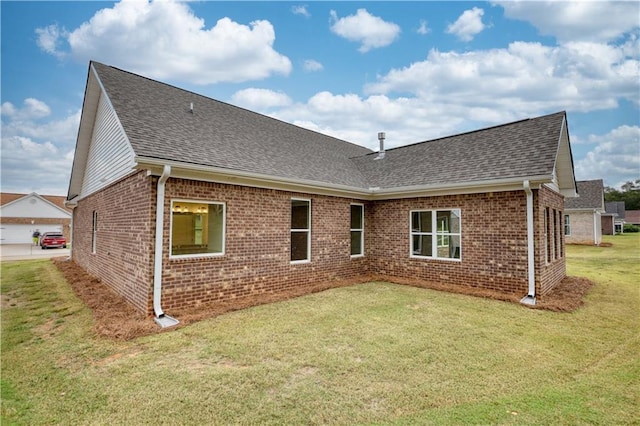 rear view of house featuring a lawn