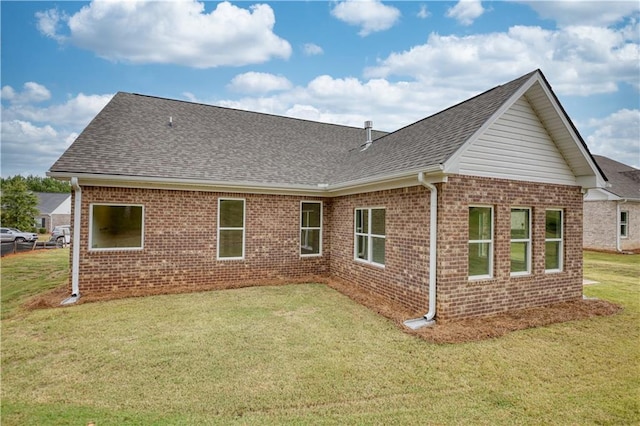 rear view of house with a yard