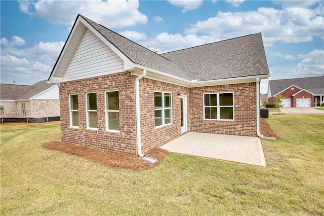 rear view of house featuring a patio, a yard, and cooling unit