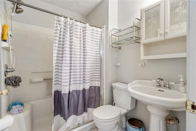 bathroom featuring toilet and a textured ceiling