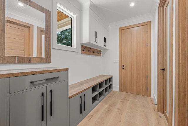mudroom with recessed lighting, baseboards, and light wood finished floors
