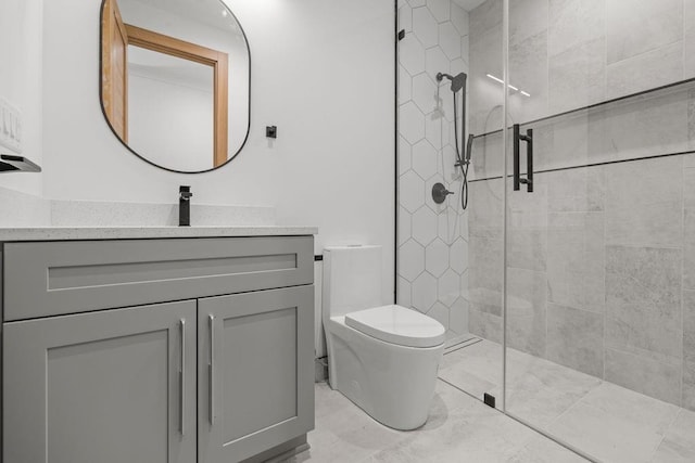 full bathroom with toilet, tiled shower, and vanity