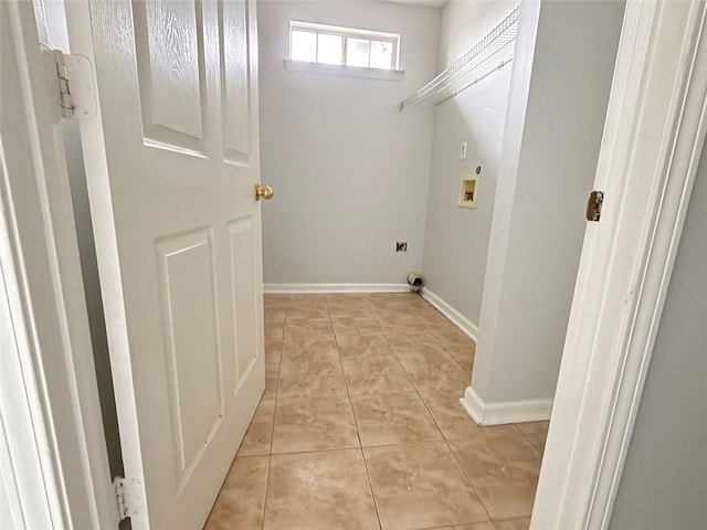 washroom with washer hookup and light tile patterned floors