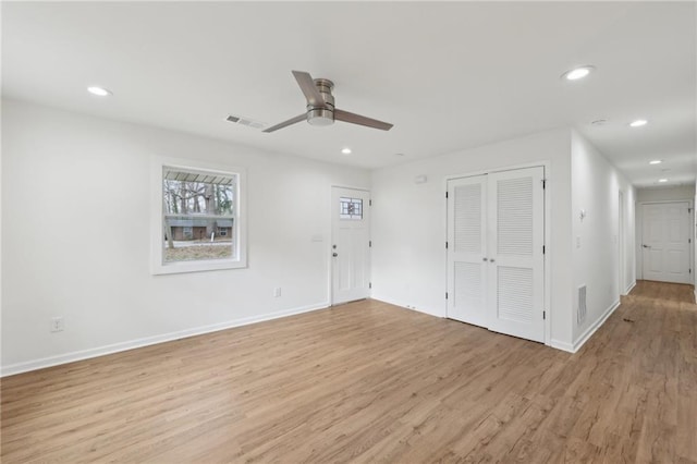 interior space featuring recessed lighting, baseboards, visible vents, and light wood finished floors