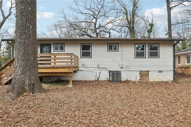 rear view of property featuring crawl space, central AC, and a wooden deck