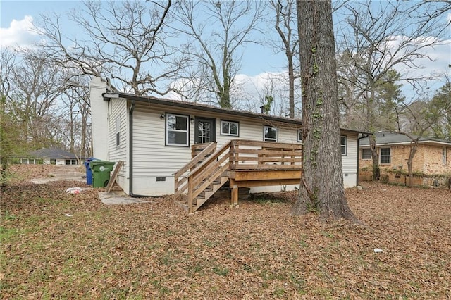 rear view of house featuring stairway, crawl space, a chimney, and a wooden deck