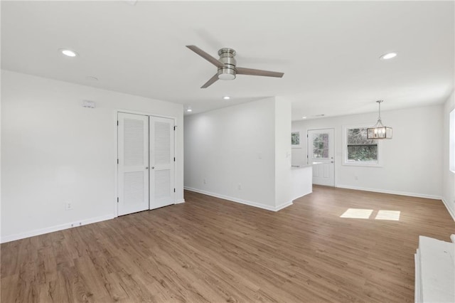 spare room with recessed lighting, baseboards, and wood finished floors