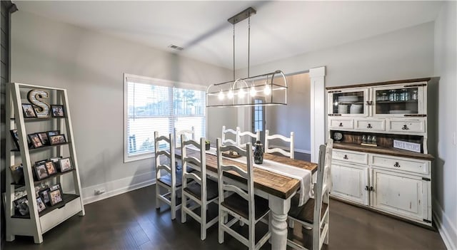 dining area with dark hardwood / wood-style floors