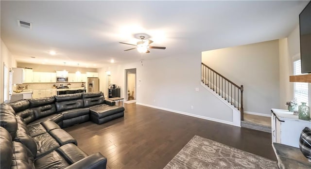 living room with ceiling fan and dark hardwood / wood-style floors