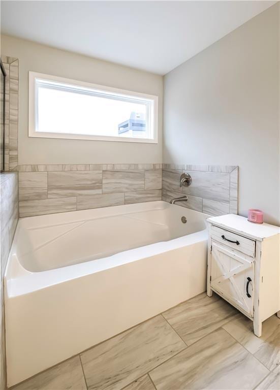 bathroom featuring tile patterned floors and a bathtub