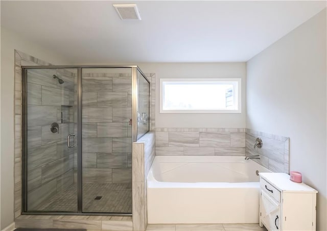 bathroom with plus walk in shower and tile patterned flooring