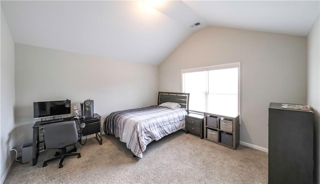 bedroom with light colored carpet and lofted ceiling