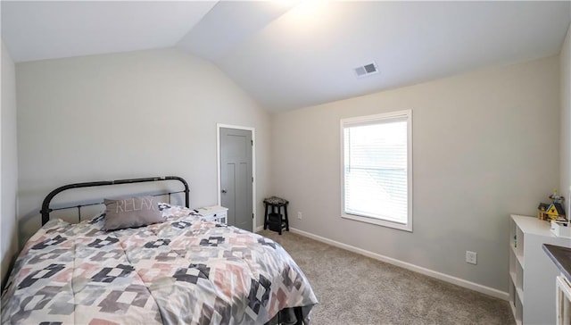 carpeted bedroom with vaulted ceiling