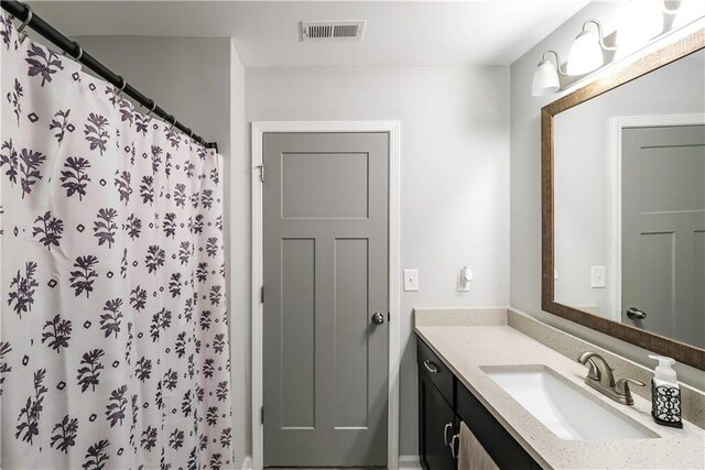 bathroom with vanity and a shower with shower curtain